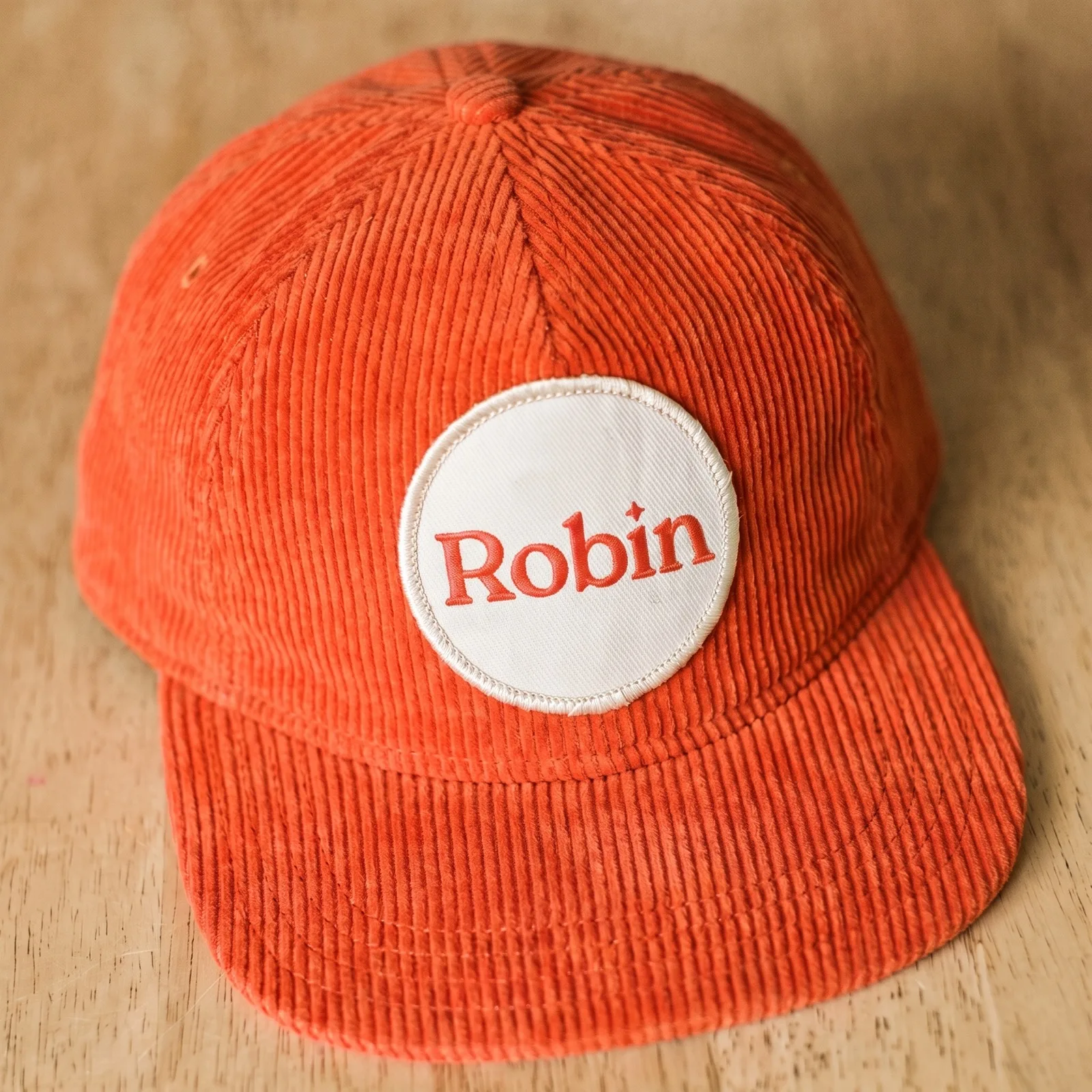 Orange Robin corduroy cap with embroidered patch